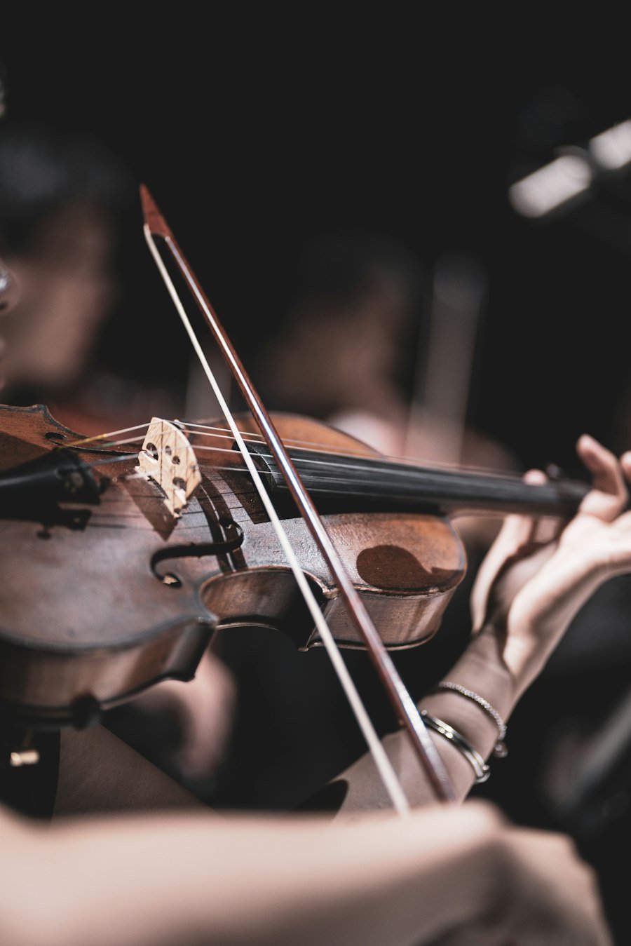 Bow on violin strings, close-up